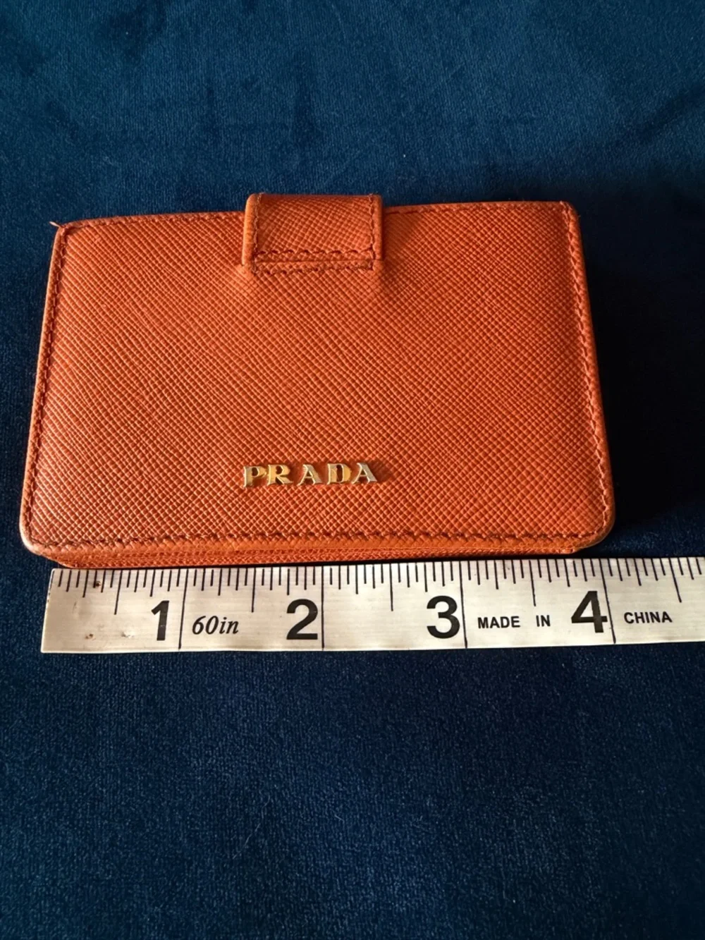 Orange Prada Saffiano Leather accordion card holder.